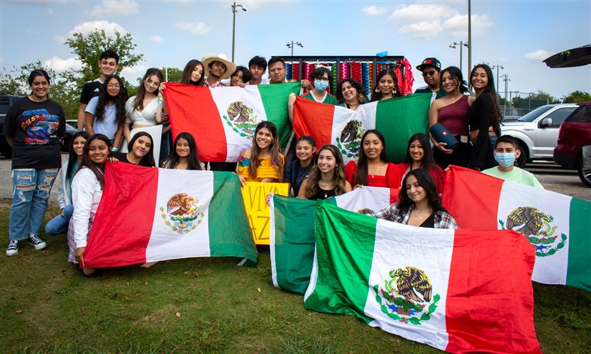 Students celebrate while on a homecoming parade float